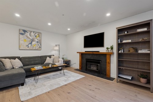 102-1689 4Th Avenue E, Vancouver, BC - Indoor Photo Showing Living Room With Fireplace