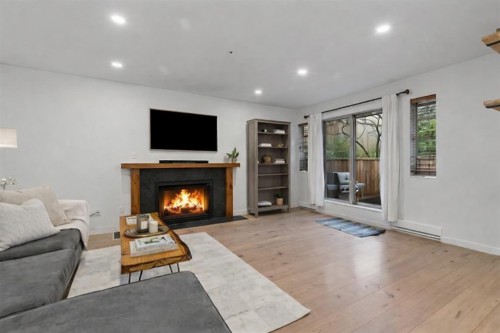 102-1689 4Th Avenue E, Vancouver, BC - Indoor Photo Showing Living Room With Fireplace