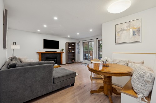 102-1689 4Th Avenue E, Vancouver, BC - Indoor Photo Showing Living Room With Fireplace