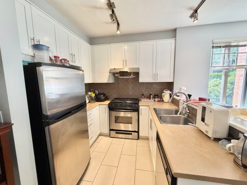103-4883 Maclure Mews, Vancouver, BC - Indoor Photo Showing Kitchen With Stainless Steel Kitchen With Double Sink