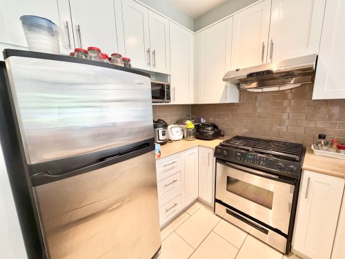 103-4883 Maclure Mews, Vancouver, BC - Indoor Photo Showing Kitchen With Stainless Steel Kitchen