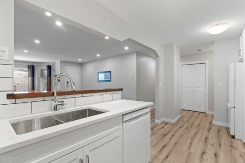 A102-4811 53 Street, Delta, BC - Indoor Photo Showing Kitchen With Double Sink