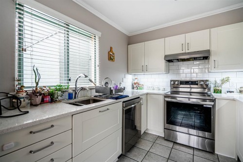 P02-223 Mountain Highway, North Vancouver, BC - Indoor Photo Showing Kitchen With Double Sink
