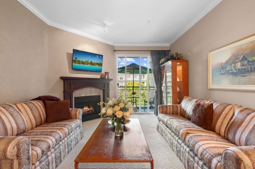 340-3098 Guildford Way, Coquitlam, BC - Indoor Photo Showing Living Room With Fireplace