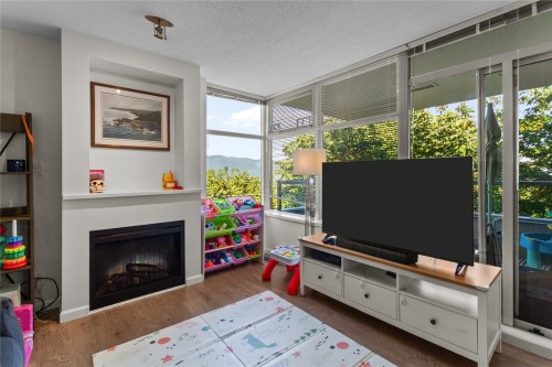 307-9298 University Crescent, Burnaby, BC - Indoor Photo Showing Living Room With Fireplace