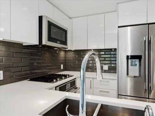 302-8533 River District Crossing, Vancouver, BC - Indoor Photo Showing Kitchen With Stainless Steel Kitchen With Upgraded Kitchen