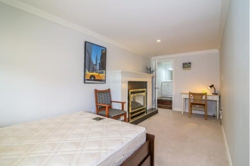 8820 No. 4 Road, Richmond, BC - Indoor Photo Showing Bedroom With Fireplace