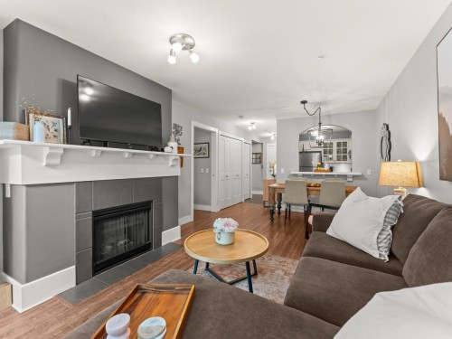 117-5900 Dover Crescent, Richmond, BC - Indoor Photo Showing Living Room With Fireplace