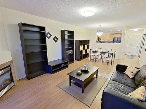 119 12110 106 Avenue Nw, Edmonton, AB - Indoor Photo Showing Living Room With Fireplace