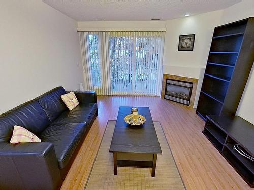 119 12110 106 Avenue Nw, Edmonton, AB - Indoor Photo Showing Living Room With Fireplace