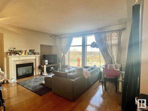 306 9020 Jasper Avenue, Edmonton, AB - Indoor Photo Showing Living Room With Fireplace