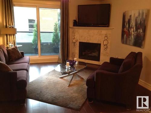 223 10142 111 Street Nw, Edmonton, AB - Indoor Photo Showing Living Room With Fireplace