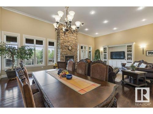 80 Riverstone Close, Rural Sturgeon County, AB - Indoor Photo Showing Dining Room With Fireplace