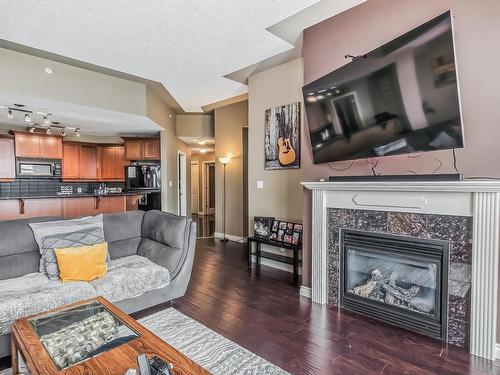 1705 9020 Jasper Avenue, Edmonton, AB - Indoor Photo Showing Living Room With Fireplace