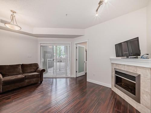 117 10333 112 Street, Edmonton, AB - Indoor Photo Showing Living Room With Fireplace