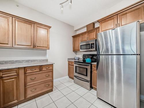 313 9739 92 Street, Edmonton, AB - Indoor Photo Showing Kitchen With Stainless Steel Kitchen