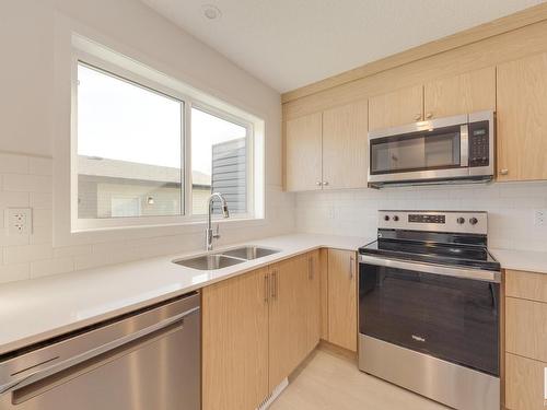 121 Stiles Link, Leduc, AB - Indoor Photo Showing Kitchen With Stainless Steel Kitchen With Double Sink