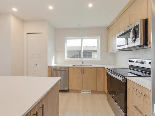 121 Stiles Link, Leduc, AB - Indoor Photo Showing Kitchen With Stainless Steel Kitchen With Double Sink With Upgraded Kitchen