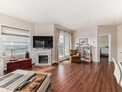 205 9927 79 Avenue, Edmonton, AB - Indoor Photo Showing Living Room With Fireplace