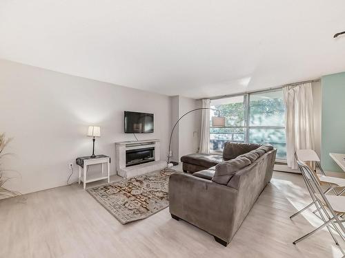 215 13910 Stony Plain Road, Edmonton, AB - Indoor Photo Showing Living Room With Fireplace