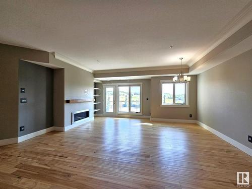 306 5201 Brougham Drive, Drayton Valley, AB - Indoor Photo Showing Living Room With Fireplace