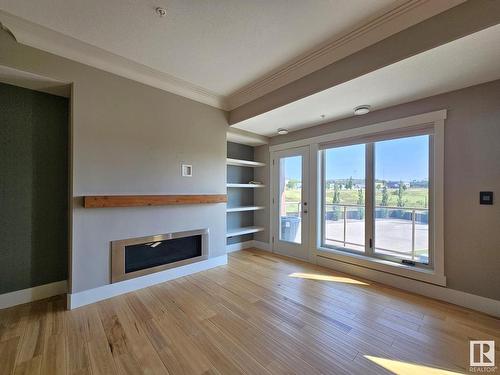 306 5201 Brougham Drive, Drayton Valley, AB - Indoor Photo Showing Living Room With Fireplace