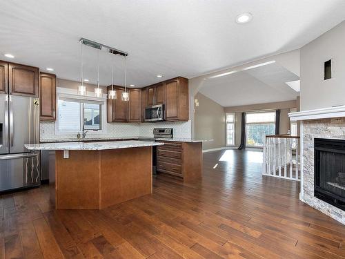 108 Ravine Villa(S), Leduc, AB - Indoor Photo Showing Kitchen With Fireplace