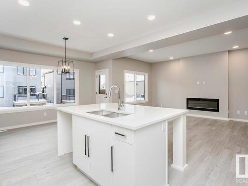 27 Cannes Cove, St. Albert, AB - Indoor Photo Showing Kitchen With Fireplace