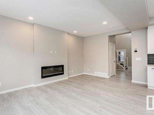 27 Cannes Cove, St. Albert, AB - Indoor Photo Showing Other Room With Fireplace