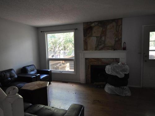 Edmonton, AB - Indoor Photo Showing Living Room With Fireplace