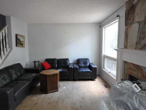 Edmonton, AB - Indoor Photo Showing Living Room With Fireplace