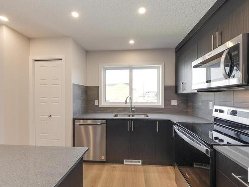 127 Stiles Link, Leduc, AB - Indoor Photo Showing Kitchen With Stainless Steel Kitchen With Double Sink