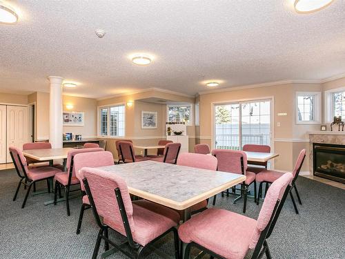 101 17150 94A Avenue, Edmonton, AB - Indoor Photo Showing Dining Room With Fireplace