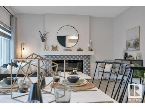 532 Bluff Lane, Leduc, AB - Indoor Photo Showing Dining Room With Fireplace