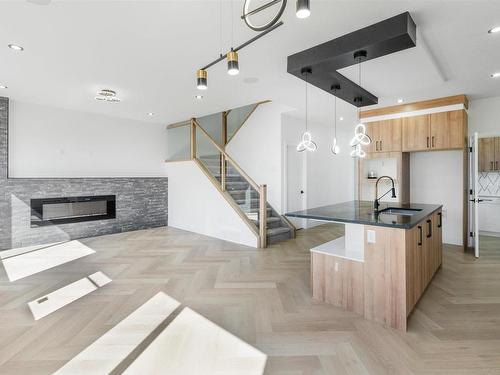 195 Ravine Drive, Devon, AB - Indoor Photo Showing Kitchen With Fireplace