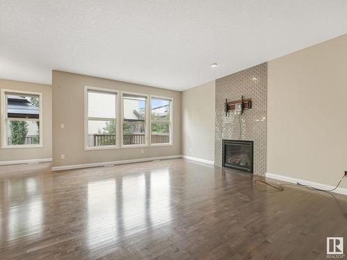 479 Ainslie Crescent Sw, Edmonton, AB - Indoor Photo Showing Living Room With Fireplace