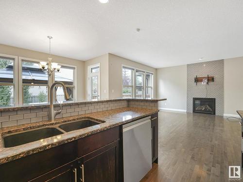 479 Ainslie Crescent Sw, Edmonton, AB - Indoor Photo Showing Kitchen With Fireplace With Double Sink