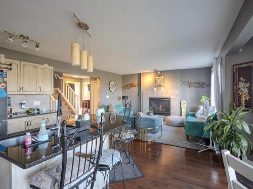 76 Dalquist Bay, Leduc, AB - Indoor Photo Showing Other Room With Fireplace