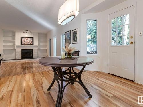 6 Bonin Place, Leduc, AB - Indoor Photo Showing Dining Room With Fireplace