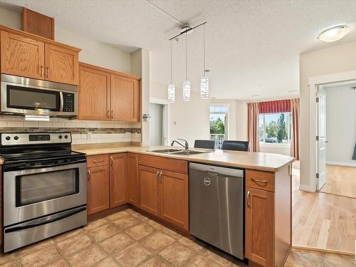 241 511 Queen Street, Spruce Grove, AB - Indoor Photo Showing Kitchen With Double Sink