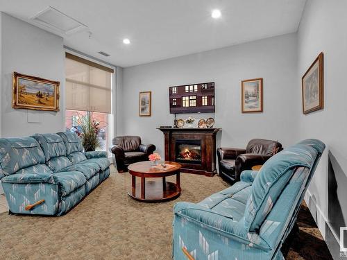 708 6608 28 Avenue, Edmonton, AB - Indoor Photo Showing Living Room With Fireplace