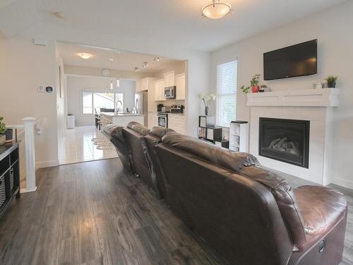 102 Gilmore Way, Spruce Grove, AB - Indoor Photo Showing Living Room With Fireplace