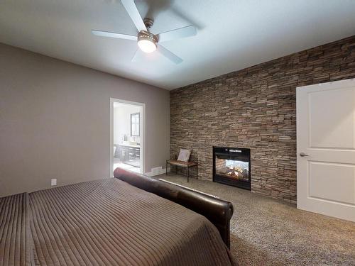 10919-175 Avenue, Edmonton, AB - Indoor Photo Showing Bedroom With Fireplace