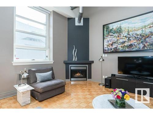 203 10009 102 Avenue, Edmonton, AB - Indoor Photo Showing Living Room With Fireplace