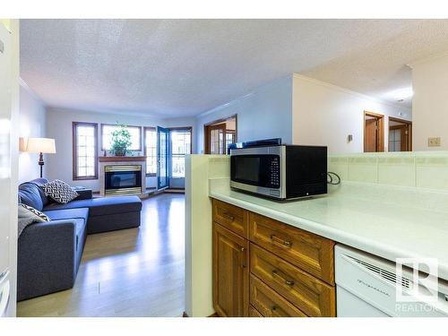 218 17151 94A Avenue, Edmonton, AB - Indoor Photo Showing Living Room With Fireplace