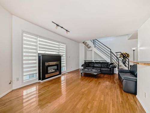 114 10933 82 Avenue, Edmonton, AB - Indoor Photo Showing Living Room With Fireplace