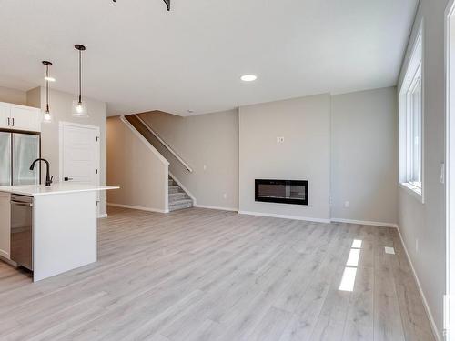 338 Genesis Villa(S), Stony Plain, AB - Indoor Photo Showing Other Room With Fireplace