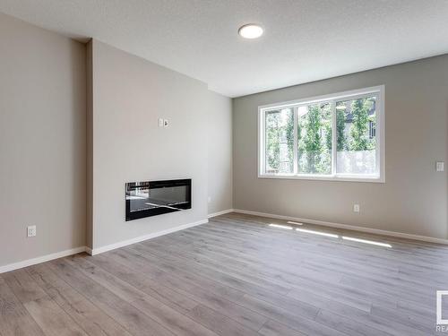 338 Genesis Villa(S), Stony Plain, AB - Indoor Photo Showing Living Room With Fireplace