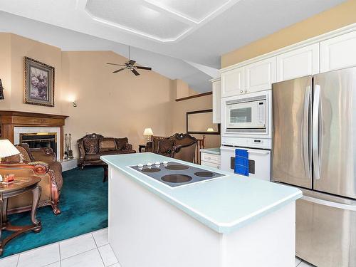 474062 A Highway 2A, Rural Wetaskiwin County, AB - Indoor Photo Showing Kitchen With Fireplace