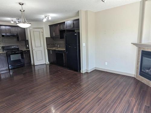 25 1820 34 Avenue, Edmonton, AB - Indoor Photo Showing Kitchen With Fireplace